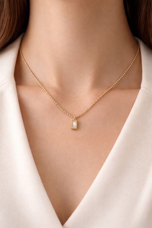 Zarinis Chunky Gold Chain With White Crystal Pendant Highlighting Polished Gold Toned Finish
