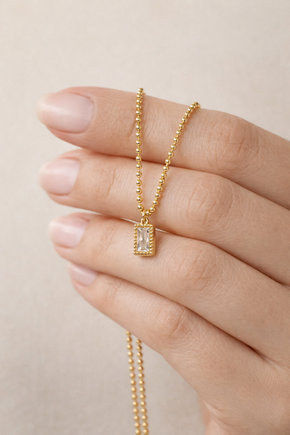 Zarini’s Chunky Gold Chain with White Crystal Pendant