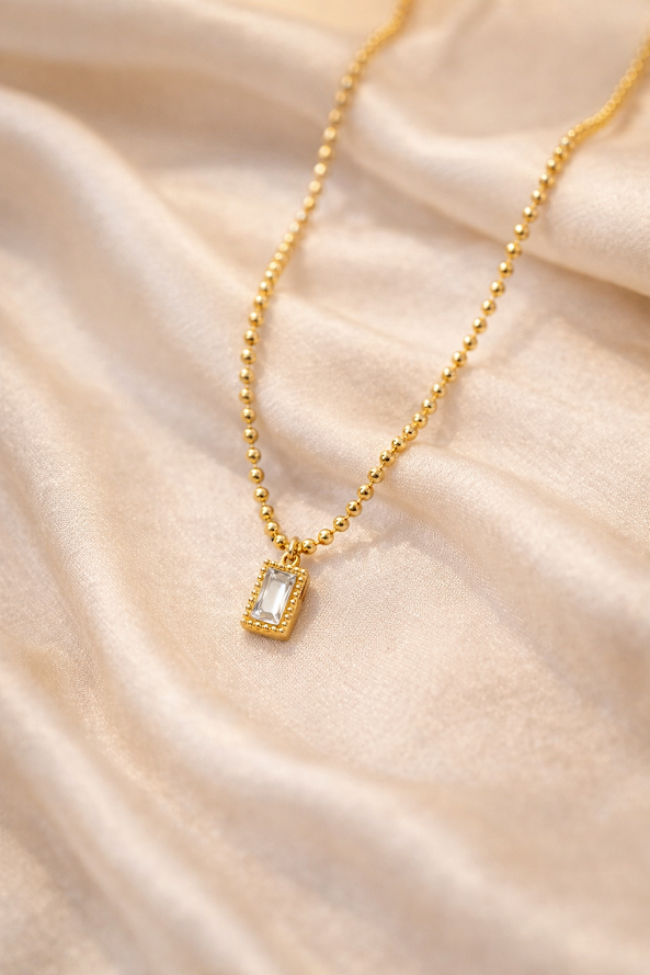 Zarini’s Chunky Gold Chain with White Crystal Pendant