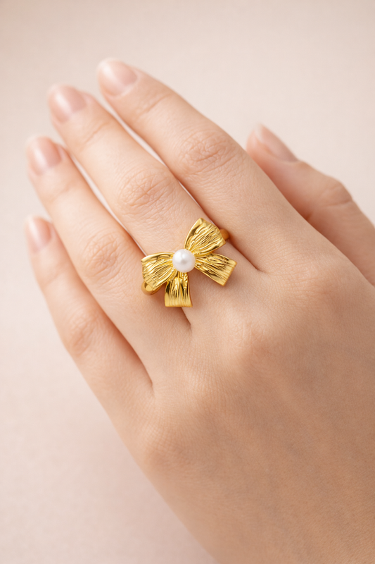 Zarini Gold Plated Bow Ring Anti Tarnish Design With Central Faux Pearl Highlighting Pearl Center Detail