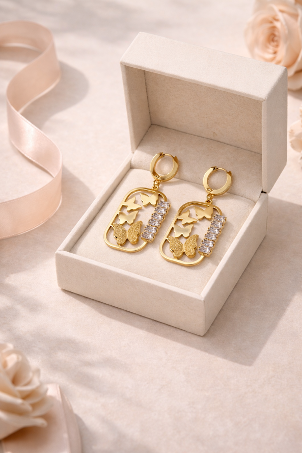 zarini’s pair of gold butterfly dangle earrings