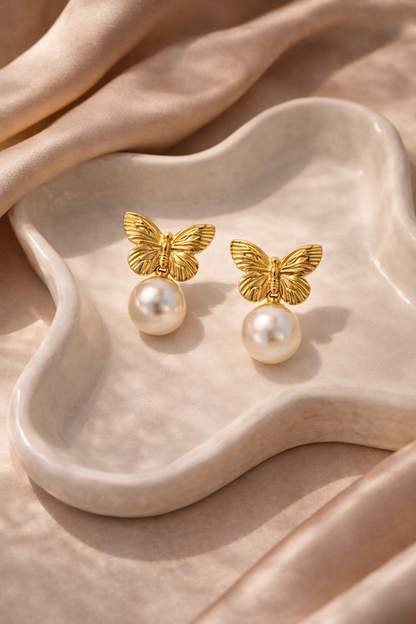 Zarini’s pair of gold-toned butterfly pearl drop earrings