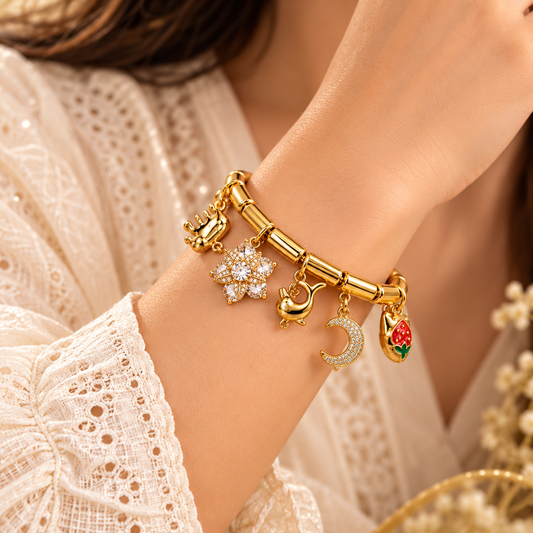 Zarini Gold-Tone Crystal Charm Bracelet for Women | Moon, Dolphin & Floral Charms